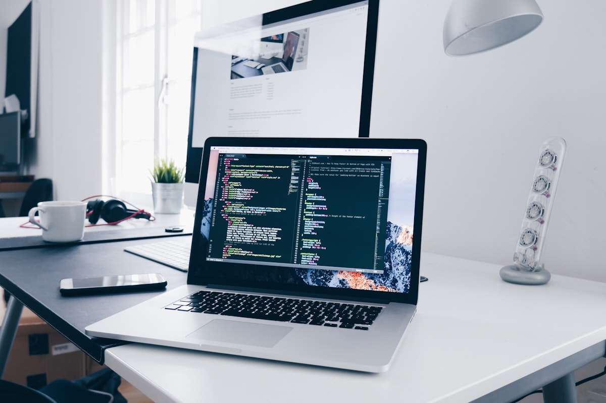 Laptop screen filled with code representing automated agent labour