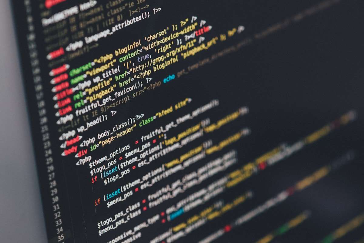 Lines of code on a developer's monitor in low light